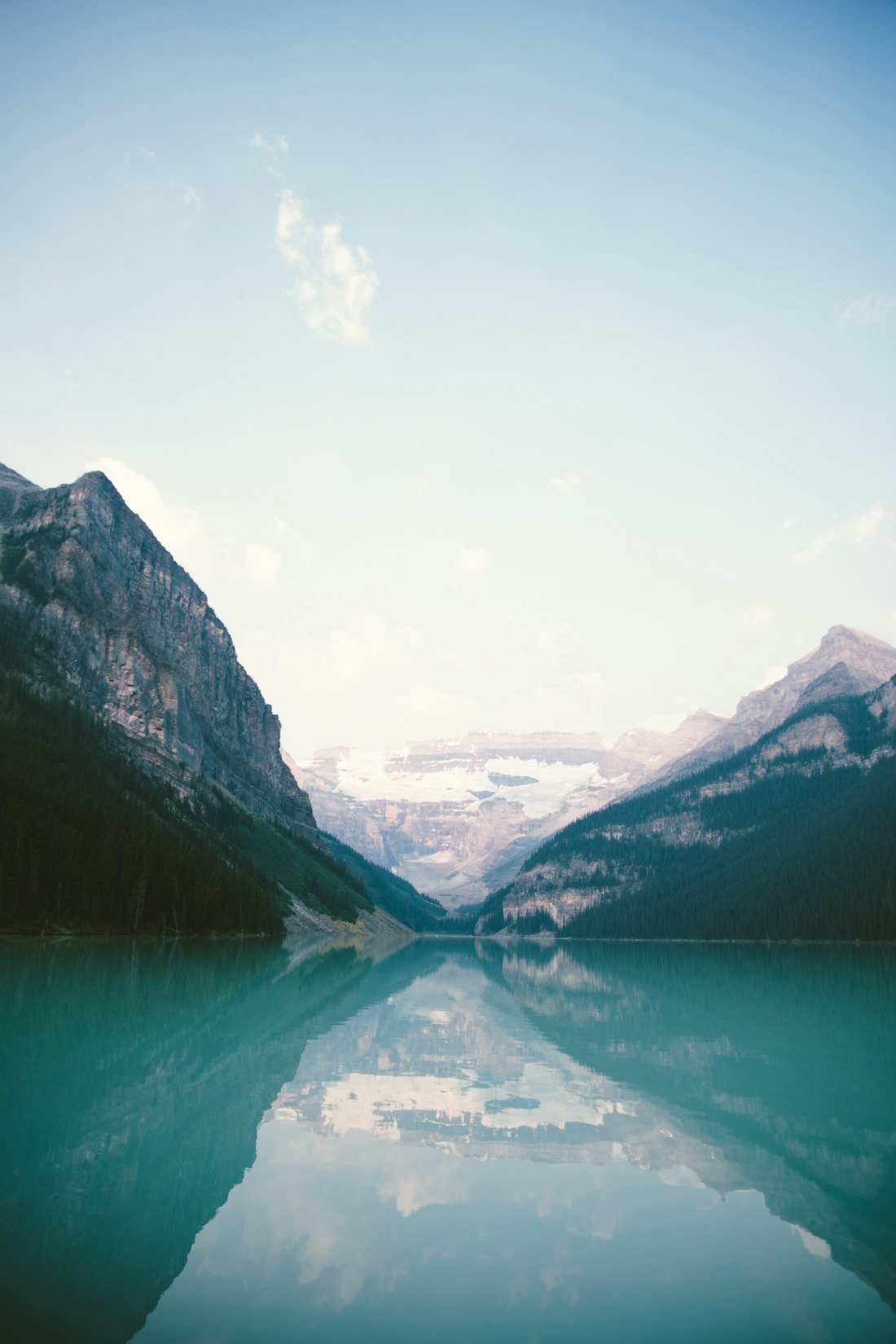 Misty mountains above a still lake