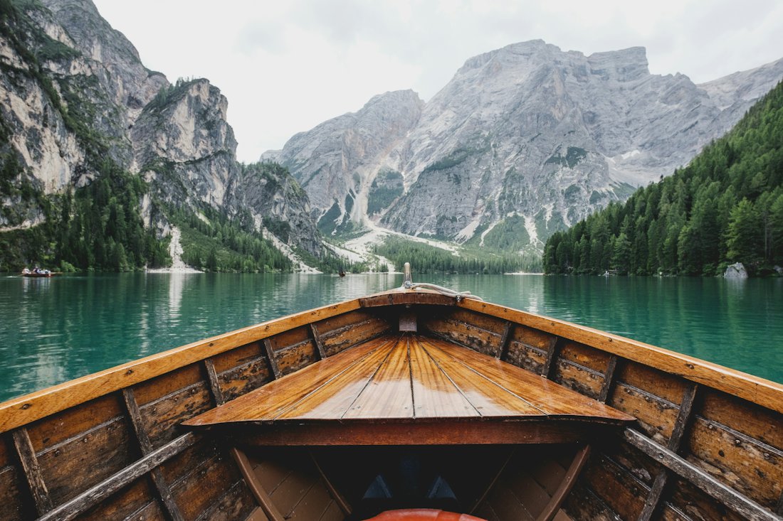 Wooden boat on a clear mountain lake